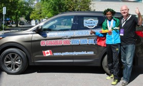 Yemane Tsegay and sponsor pose with Hyundai SUV
